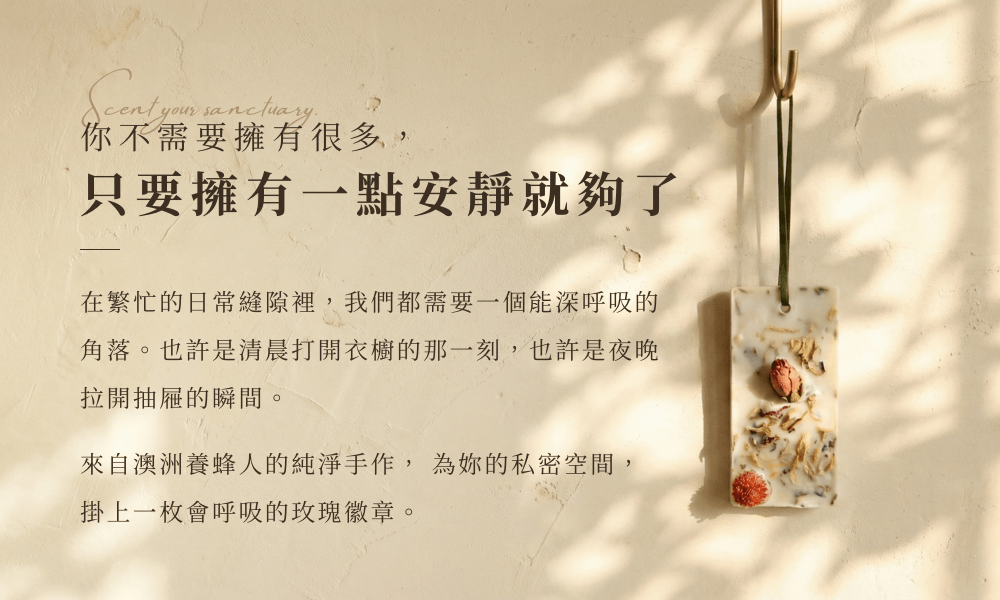 [奧圖玫瑰香氛蠟牌] 掛於米色牆面的長方形有機大豆蠟牌，表面鑲嵌立體乾燥玫瑰花苞。光影溫暖斑駁，標題寫著「你不需要擁有更多，只要擁有一點安靜就夠了」，營造居家療癒氛圍。